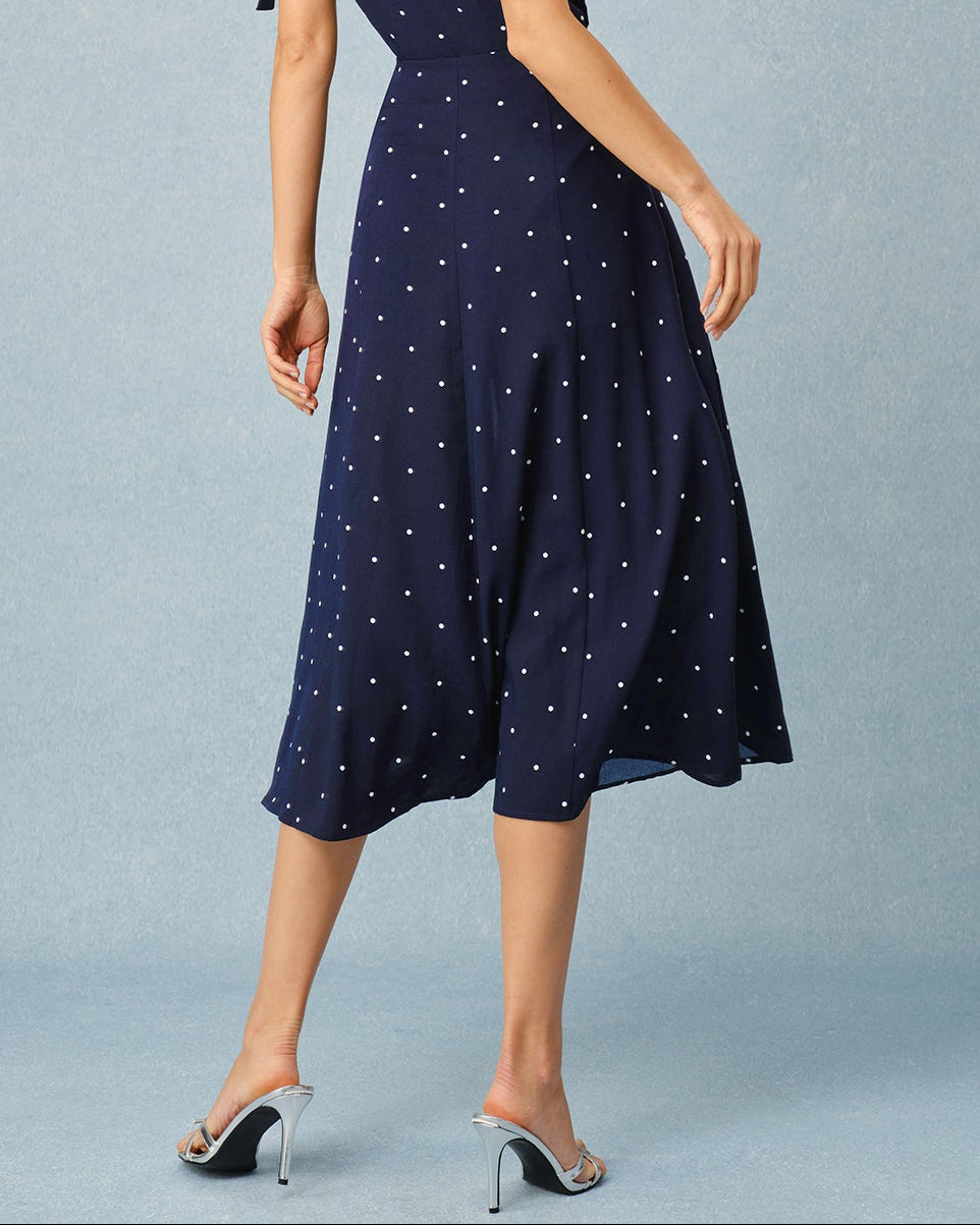 Norelle – Falda midi azul marino con estampado de lunares y abertura
